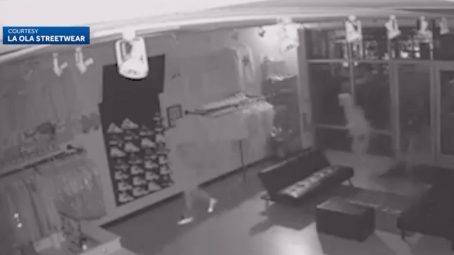 An image taken from surveillance footage within the La Ola Sportswear store, with two of the five alleged robbers entering the location.