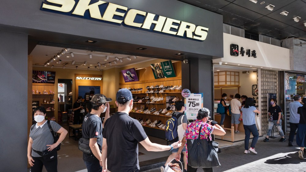 Pedestrians walk past the American lifestyle and performance footwear brand Skechers store in Hong Kong.