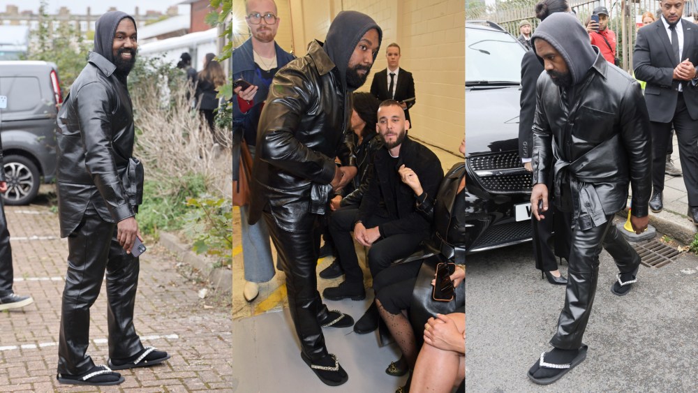 Kanye West wears glitter flip-flops with socks on to the Burberry spring 2023 show.
