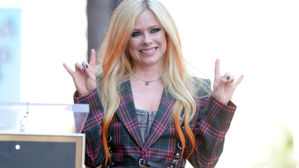Avril Lavigne wears tartan vivienne westwood suit and harness at the star ceremony where Avril Lavigne is honored with a star on the Hollywood Walk of Fame on August 31, 2022 in Los Angeles, California.