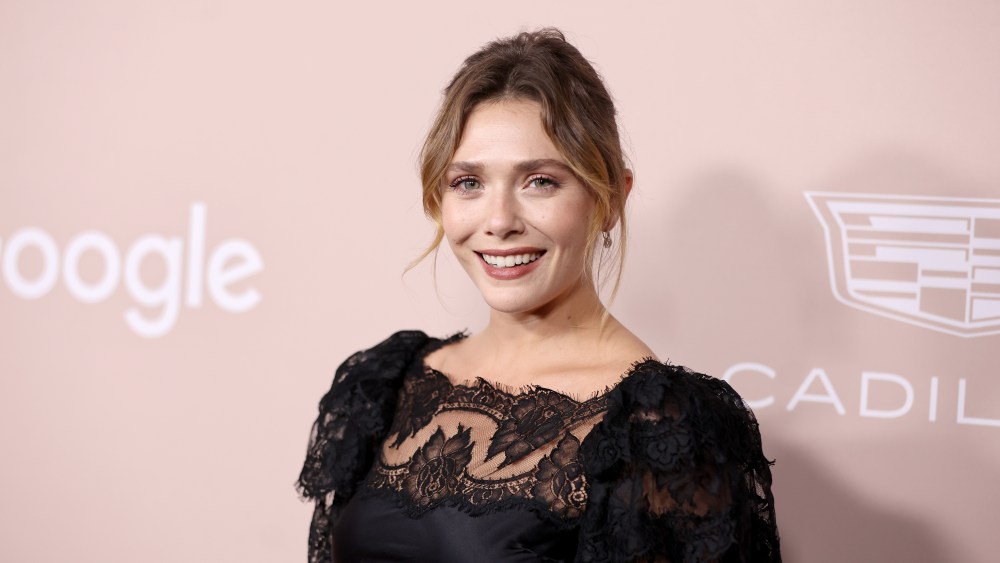 Elizabeth Olsen in black lace rodarte dress attends Variety's Power of Women on Sept. 28 in Beverly Hills, California.