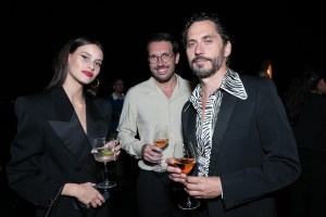 LOS ANGELES, CALIFORNIA - OCTOBER 20: (L-R) Milena Smit, guest, and Paco León are seen as Dom Pérignon and Lady Gaga pursue their creative dialogue at Sheats Goldstein Residence on October 20, 2022 in Los Angeles, California. (Photo by Kevin Mazur/Getty Images for Dom Pérignon)