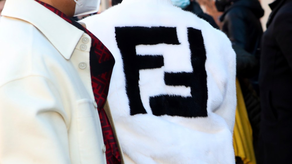 Fendi's logo is seen on a fur coat of a guest at Fendi during the MFW 2022 in Milan, Italy, on 15 January 2022 (Photo by Mairo Cinquetti/NurPhoto via AP)