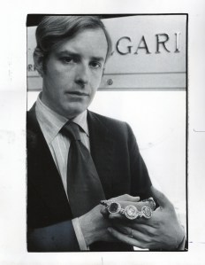 Mr. Nicola Bulgari inside the Bulgari Store at Hotel Pierre showing a necklace with coins, 1975.
