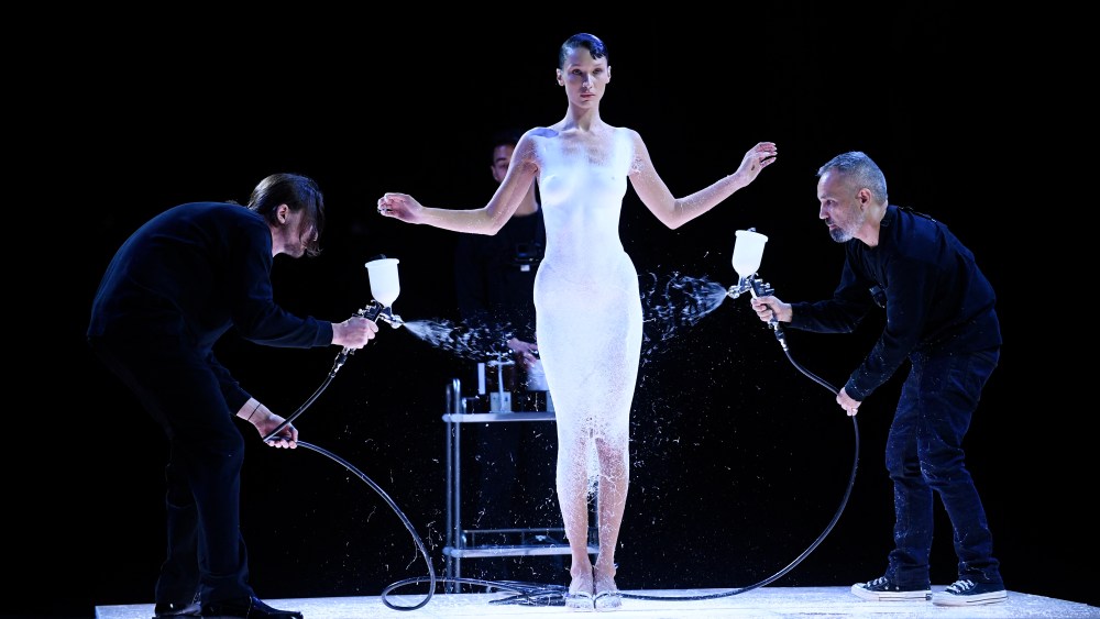 Bella Hadid is dressed by spraying Fabrican Spray-on fabric during the Coperni spring 2023 show.