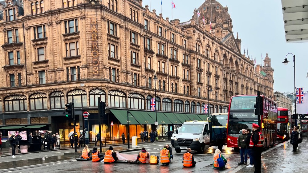 Just Stop Oil protesters blocking the road outside of Harrods' Knightsbridge store.