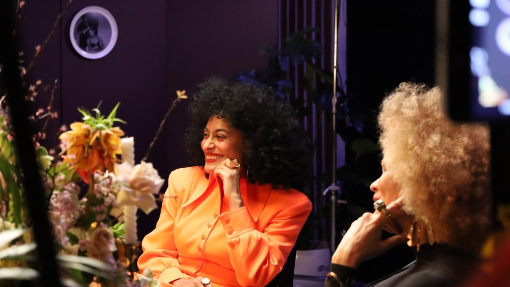Tracee laughing at Marsai from across the table
