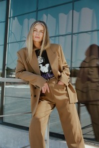 Khaite’s wool drape jacket and pants with stylist’s own vintage T-shirt and belt. Isabel Marant boots; Joanna Laura ring.