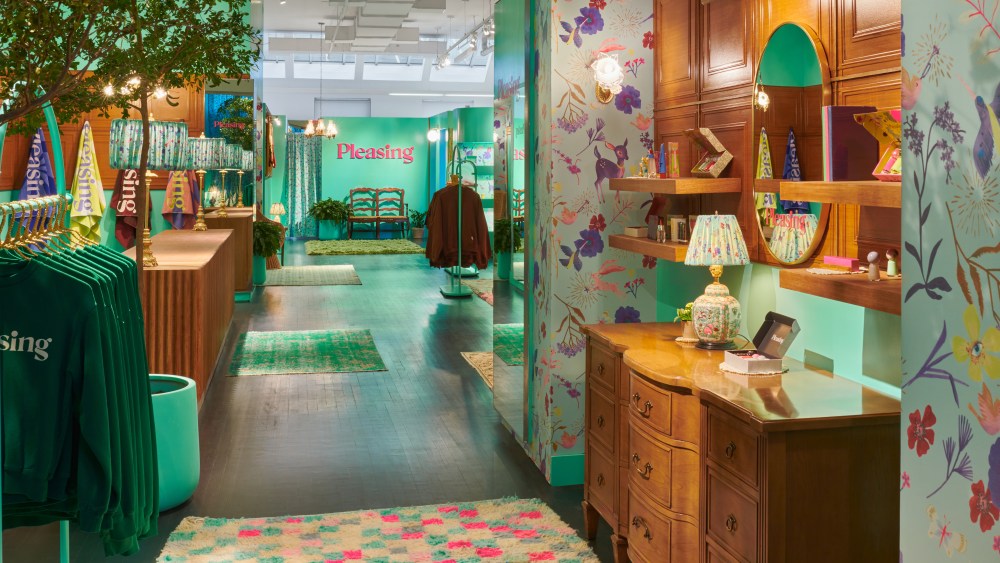 Inside Pleasing's New York City pop-up, which opens Nov. 26 features warm wood furniture with bright green paint and decor throughout.