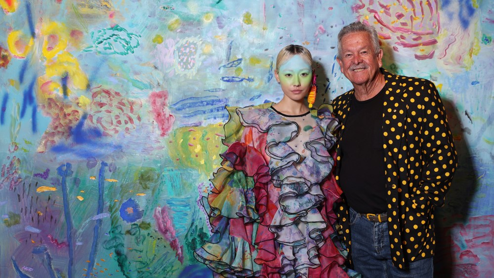 Ken Done with a model in a look from the Romance Was Born x Ken Done Resort 2023 collection during Afterpay Australian Fashion Week's 2022 showcase, Ken Done Gallery, The Rocks, Sydney, May 9, 2022.