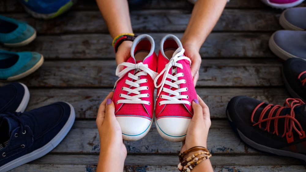 Used shoes in the hands of two women