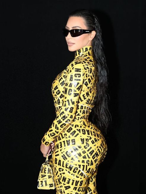 Kim Kardashian wearing a dress made of caution tape that has become the sticking point of one Balenciaga conspiracy theory in particular.
