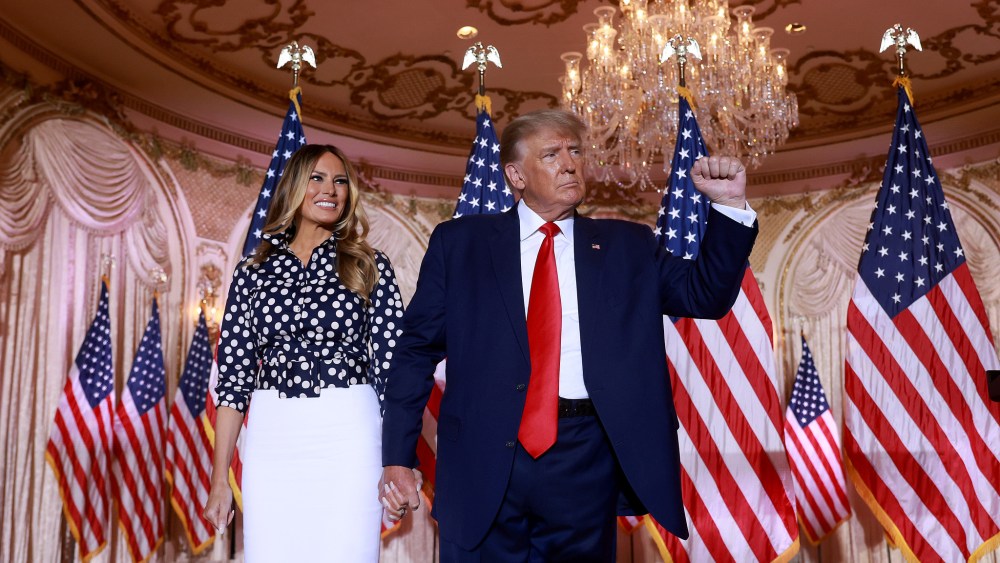 Former U.S. President Donald Trump and former first lady Melania Trump stand together during an event at his Mar-a-Lago home on November 15, 2022.