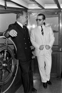 Karl Lagerfeld and ship captain arrive at the Grove Isle Club  during the 34th Neiman Marcus Awards ceremony and benefit on March 3, 1980 in Coral Gables, Florida.