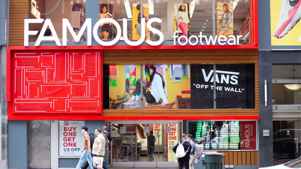 A woman exits from a Famous Footwear Store in Midtown New York.