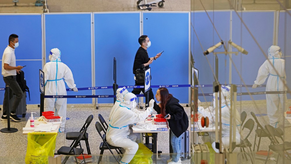 Travelers receive COVID-19 swab tests at Shanghai Hongqiao International Airport on Oct. 12, 2022.
