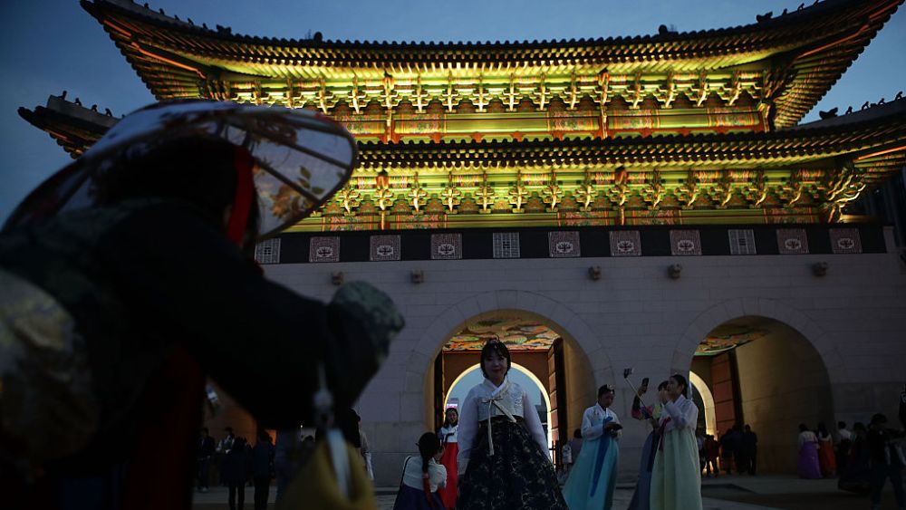SEOUL, SOUTH KOREA - OCTOBER 22:  People wearing the South Korean traditional costume 'HanBok' and enjoy the fashion show at Gyeongbok Palace on October 22, 2016 in Seoul, South Korea. Hanbok is the traditional Korean dress. It is often characterized by vibrant colors and simple lines without pockets. Although the term literally means 'Korean clothing', hanbok today often refers specifically to hanbok of Joseon Dynasty and is worn as semi-formal or formal wear during traditional festivals and celebrations.  (Photo by Chung Sung-Jun/Getty Images)