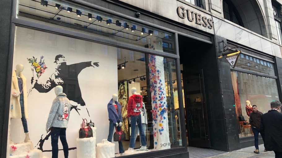 Banksy is fighting with Guess over using his famous graphic artowrk for a capsule collection.