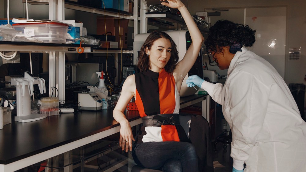 Sr. Microbiome Scientist Laurice Flowers, PhD swabs Aganovic, testing an upcoming product.