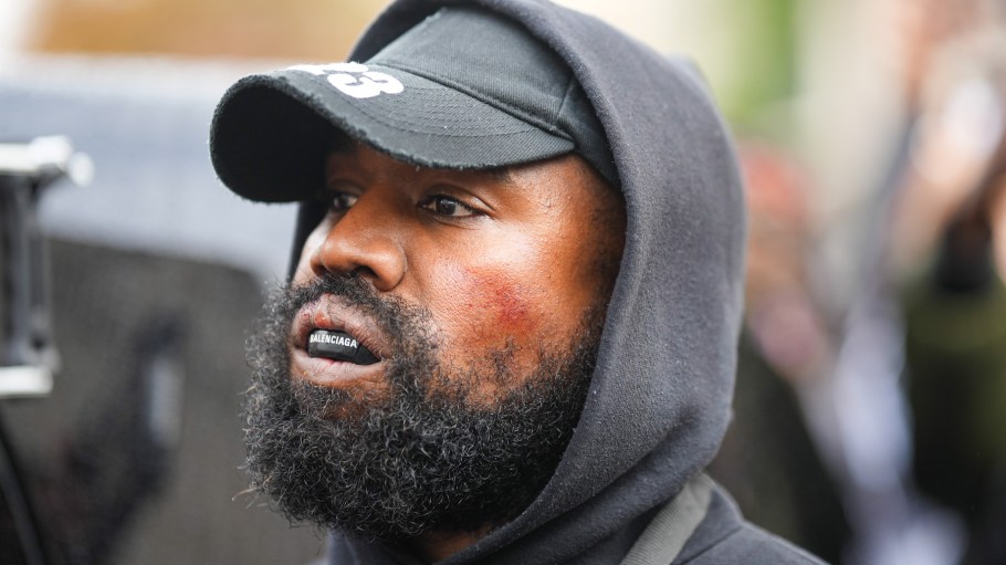 Kanye West aka Ye is seen wearing a Balenciaga boxing mouthguard, outside Givenchy, during Paris Fashion Week
