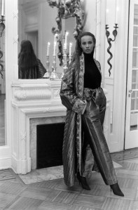 Iman in a silk brocade robe with embellished cuffs coordinating foulard pants over a black velvet bodysuit from the Fernando Sanchez Holiday 1989 Loungewear collection.