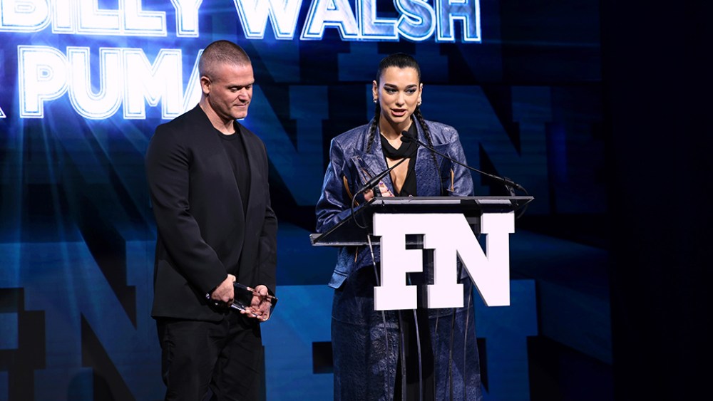 NEW YORK, NEW YORK - NOVEMBER 30: (L-R) Honorees Dua Lipa and Billy Walsh accept the Collection of the Year Award for Puma onstage during the 2022 Footwear News Achievement Awards at Cipriani South Street on November 30, 2022 in New York City. (Photo by Dimitrios Kambouris/Footwear News via Getty Images)