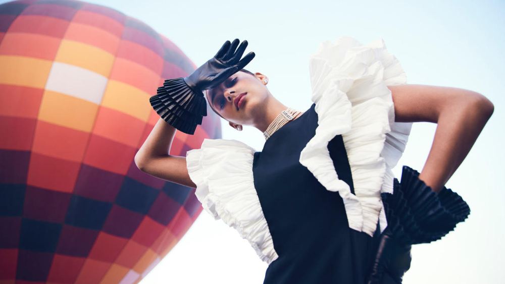 woman standing outside by hot air balloon wearing stylish women's leather gloves