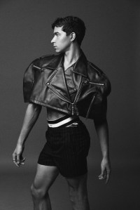 No Sesso’s leather cape and Dries Van Noten’s wool shorts worn over Thom Browne’s jockstrap. Thom Browne shoes; Pamela Love twisted sterling silver hoop earrings.