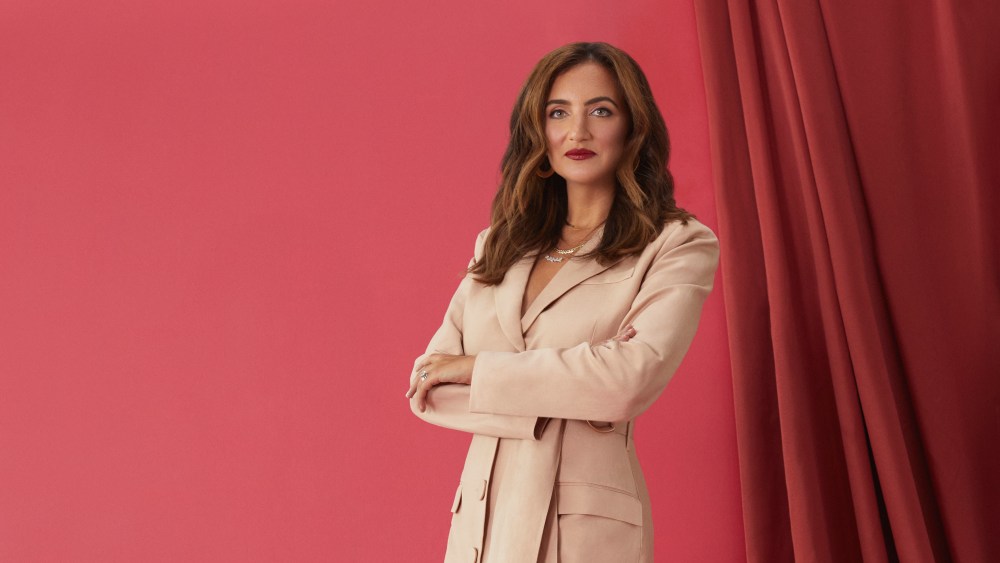 Rent the Runway's CEO Jennifer Hyman red background beige dress