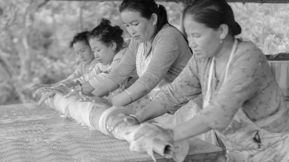 A greyscale image of four Chuba Ko weavers, one of the winning teams, for this year's competition of the Global Eco Artisan Awards.