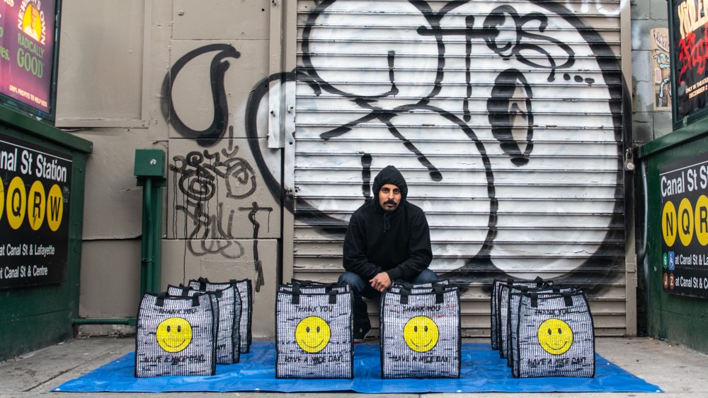 Founder Alex Dabagh of Anybag, pictured with his limited edition upcycled bags on New York's Canal Street