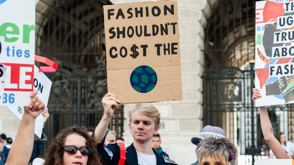 Extinction Rebellion activists demonstrate outside the Foreign Office ahead of Victoria Beckham's show at the London Fashion Week on 15 September, 2019 in London, England. Protesters call for the British Fashion Council to cancel London Fashion Week until it can be sustainable in the face of climate crisis and ecological emergency. (Photo by WIktor Szymanowicz/NurPhoto via Getty Images)