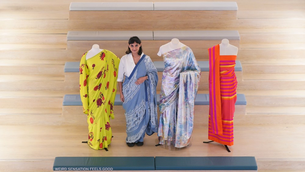 Priya Khanchandani, Head of Curatorial, wears a distressed denim sari by designer Diksha Khanna, alongside (left to right) a Folia sari, by Raw Mango, 2021; a Shimma Saree, by Norblack Norwhite, 2017, and an Ekori sari, by Raw Mango, 2022, at the Design Museum in London, for the announcement of their summer exhibition, The Offbeat Sari (running from May 19 - September 17, 2023). Picture date: Tuesday January 10, 2023. (Photo by Yui Mok/PA Images via Getty Images)