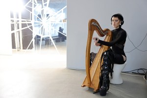 BERLIN, GERMANY - JANUARY 17: A harpist plays at the VORN -The Berlin Fashion Hub x NEWEST runway show during the Berlin Fashion Week AW23 at Kant-Garagen on January 17, 2023 in Berlin, Germany. (Photo by Andreas Rentz/Getty Images for NEWEST 2023)