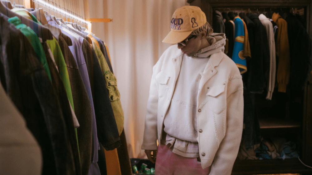 Domenico Formichetti with racks of clothes from his PDF brand.