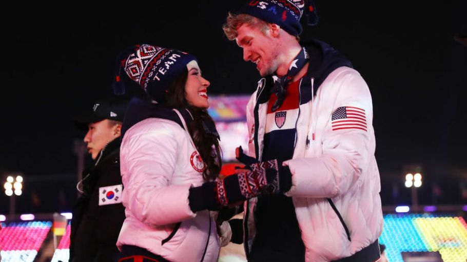Madison Chock and Evan Bates of the United States at the 2018 closing ceremonies in South Korea, wearing Ralph Lauren-designed coats manufactured by Best Team USA in Clifton, N.J.
