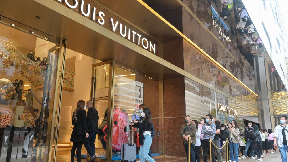 Customers lined up to enter a Louis Vuitton store in Hong Kong.