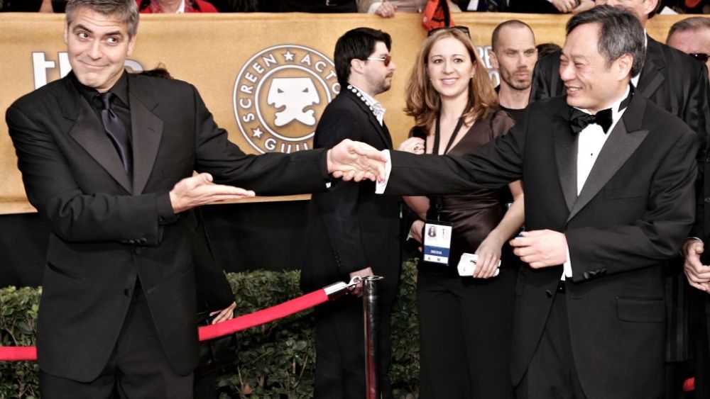 LOS ANGELES, CA - JANUARY 29:  Directors George Clooney and Ang Lee shake hands arrives at the 12th Annual Screen Actors Guild Awards held at the Shrine Auditorium on January 29, 2006 in Los Angeles, California.  (Photo by Vince Bucci/Getty Images)