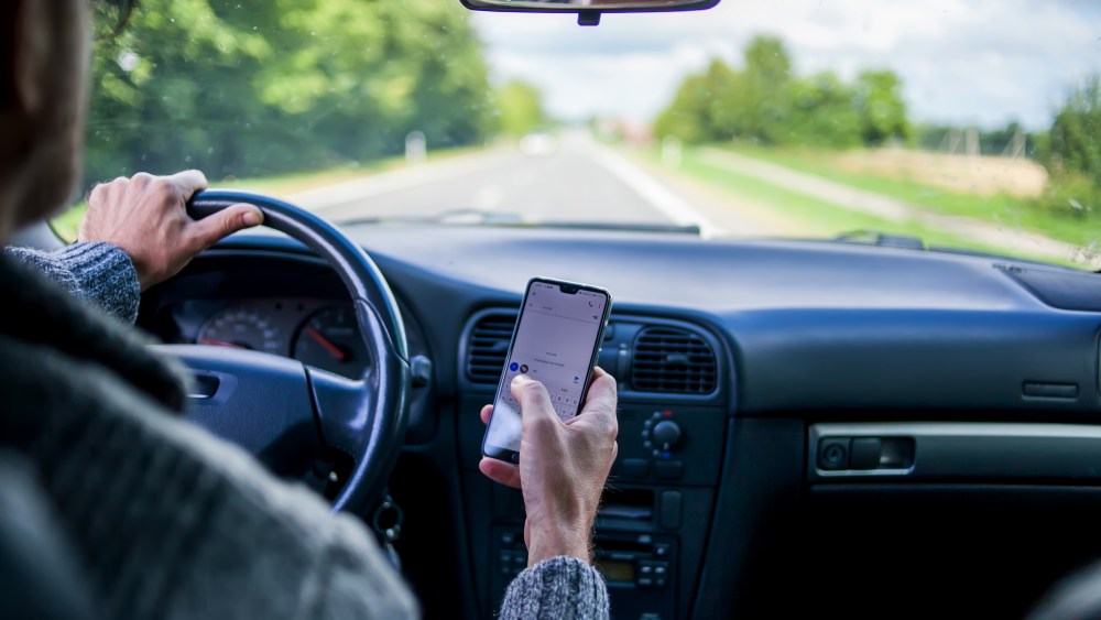 A man use sellphone while driving in the car. Road danger concept