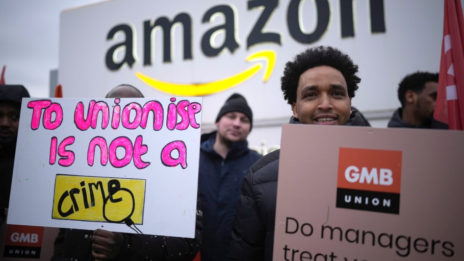Amazon workers hold GMB union placards on the picket line as they hold a strike outside the Amazon fulfilment centre on Jan. 25, 2023 in Coventry, England.