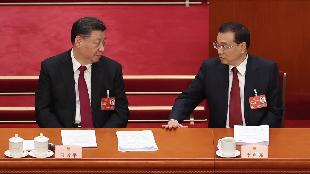 Chinese President Xi Jinping talks with Premier Li Keqiang during the opening of the first session of the 14th National People's Congress at The Great Hall of People on March 5, 2023 in Beijing, China.