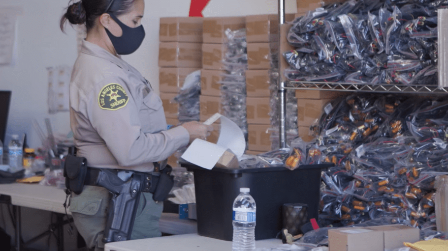 An officer for the Los Angeles County Sheriff’s Department during the execution of a search warrant at a suspected counterfeiter’s warehouse where fake auto parts were stored.