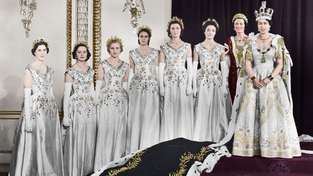 HM Queen Elizabeth II with her maids of honour, Green Drawing Room, Buckingham palace, 2nd June 1953. In selecting six Maids of Honour instead of pages to bear her velvet train throughout the Coronation ceremony, the Queen followed the precedent of Queen Victoria. Lady Moyra Hamilton (now Lady Moyra Campbell), Lady Anne Coke (now The Rt Hon The Lady Glenconner), Lady Rosemary Spencer-Churchill (now Lady Rosemary Muir), Lady Mary Baillie-Hamilton (now Lady Mary Russell), Lady Jane Heathcote-Drummond-Willoughby (now The Rt Hon The Baroness Willoughby de Eresby), Lady Jane Vane-Tempest-Stewart (now The Rt Hon The Lady Rayne). (Colorised black and white print). Artist Cecil Beaton. (Photo by The Print Collector/Getty Images)