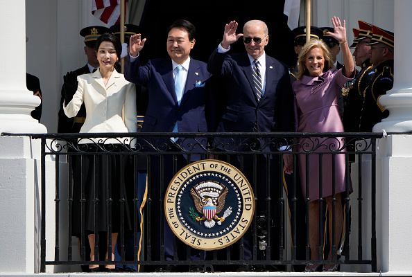 WASHINGTON, DC - APRIL 26: (L-R) South Korean first lady Kim Keon-hee, South Korean President Yoon Suk-yeol, U.S. President Joe Biden and first lady Jill Biden wave during an arrival ceremony at the White House.
