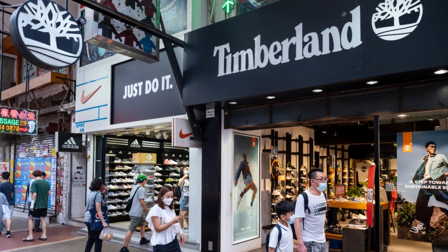 Pedestrians walk past the American clothing and footwear company brand Timberland and Nike stores in Hong Kong.