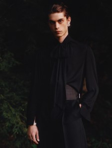Willy Chavarria’s sheer chiffon necktie blouse shirt and Gucci’s wool gabardine wide-leg pants. Saint Laurent boots; Brooks Brothers silk cummerbund; Ben-Amun by Isaac Manevitz crystal and pearl earring; model’s own pearl bracelets; Marei black onyx horn ring in blackened silver; Hirotaka black onyx pyramid ring photographed by Ivan Bideac for WWD on May 26, 2023 in Redding, Connecticut.