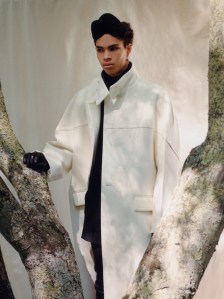 Valentino’s avorio wool coat and wool shorts and Balmain’s wool turtleneck. Rick Owens boots; Binata wool felt hat; Maison Margiela leather gloves; Thorne Dynasty dagger huggie earring with David Yurman Shark Tooth Amulet in sterling silver with pavé black diamonds photographed by Ivan Bideac for WWD on May 26, 2023 in Redding, Connecticut.