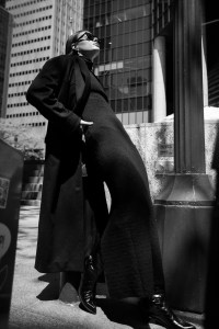 Tibi’s recycled wool, polyamide and cashmere coat and leather boots and Coach’s merino wool, silk and lycra dress. Saint Laurent sunglasses; Other People’s Property sterling silver Pearl Halo Drop Earrings with ethically sourced pearls and peridots.