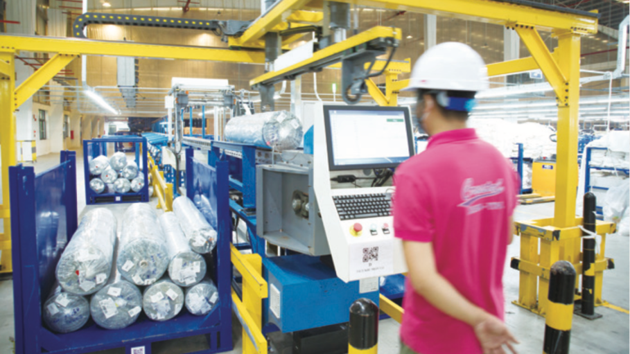 At Crystal International's denim factories, incoming fabric rolls from suppliers are machine sorted into racks before they are distributed to the corresponding workstations.