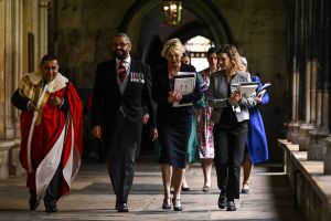 Britain's Foreign Secretary James Cleverly (2L) arrives to take his seat inside Westminster Abbey in central London on May 6, 2023, ahead of the coronations of Britain's King Charles III and Britain's Camilla, Queen Consort. - The set-piece coronation is the first in Britain in 70 years, and only the second in history to be televised. Charles will be the 40th reigning monarch to be crowned at the central London church since King William I in 1066. Outside the UK, he is also king of 14 other Commonwealth countries, including Australia, Canada and New Zealand. Camilla, his second wife, will be crowned queen alongside him, and be known as Queen Camilla after the ceremony. (Photo by Ben Stansall / POOL / AFP) (Photo by BEN STANSALL/POOL/AFP via Getty Images)